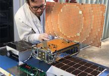 Engineer Joel Steinkraus uses sunlight to test the solar arrays on one of the Mars Cube One (MarCO) spacecraft at NASA's Jet Propulsion Laboratory.
